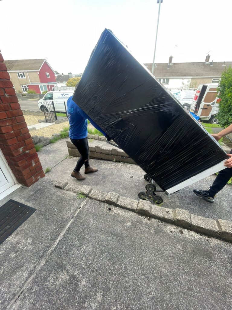 Image showing EL removals staff moving fridge