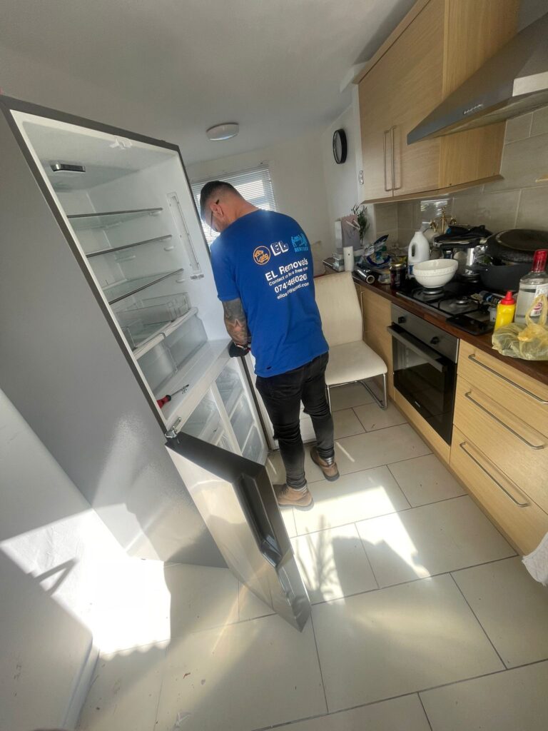 Image showing EL removals staff unscrewing fridge